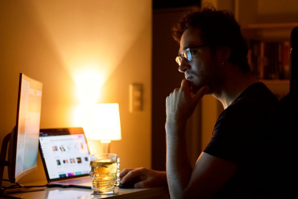 Man pondering work on computer